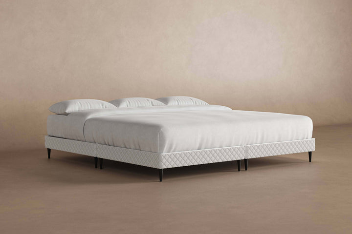 Angled view of platform bed frame with a mattress